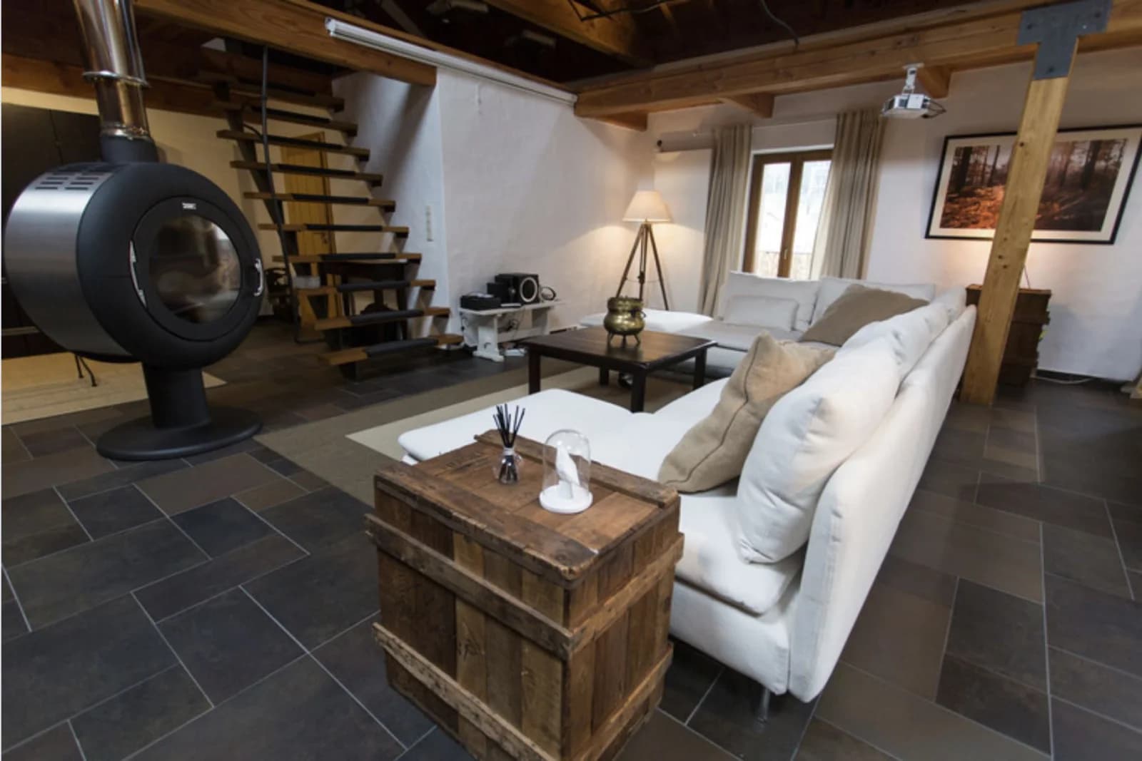 Living room in Large loft with exposed beams and stonework - 1